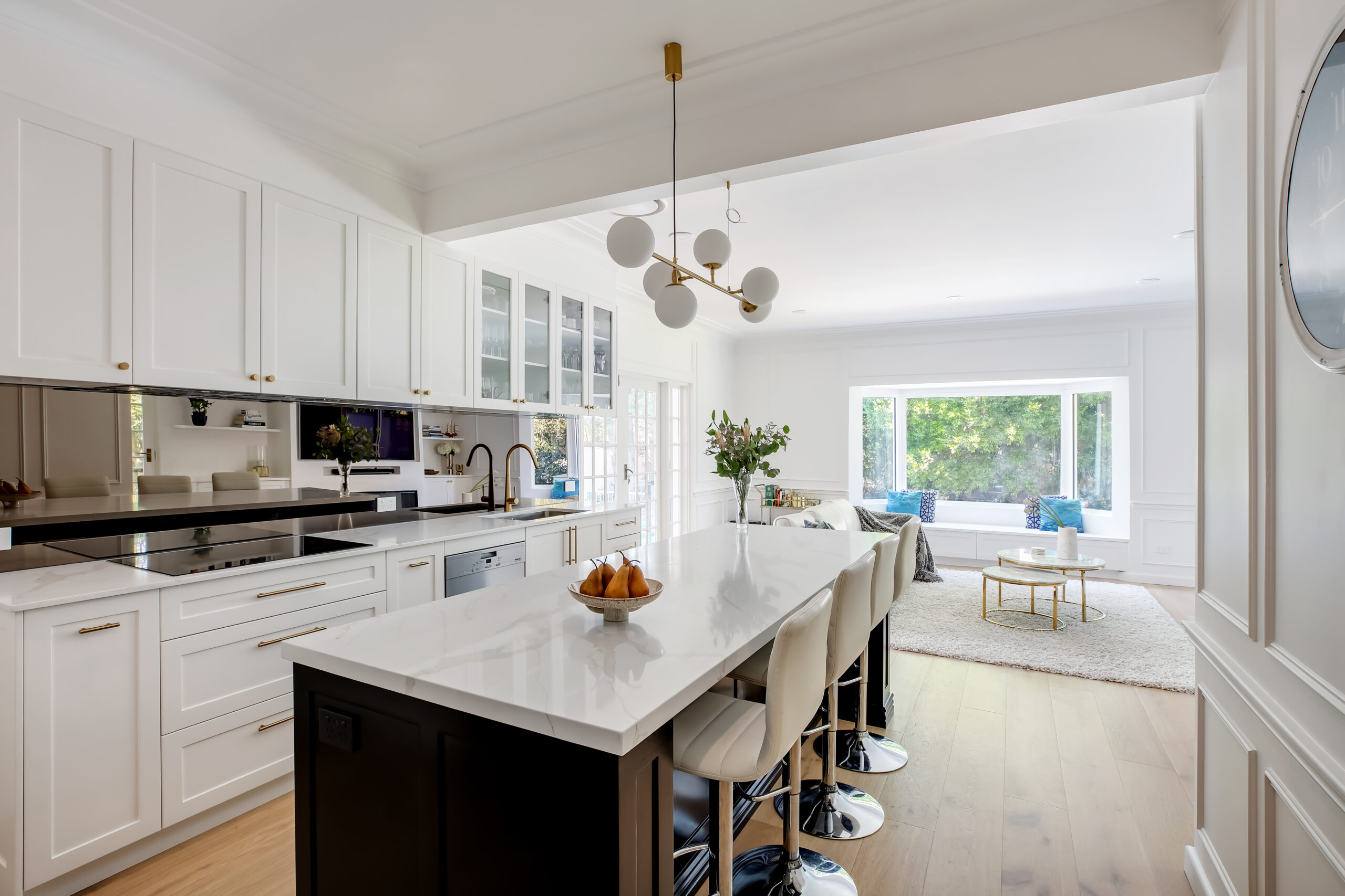 A modern kitchen renovation with a new Kitchen island finished with a white marble top.